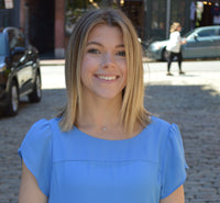 Julia Lydon; blonde women smiling wearing a blue shirt
