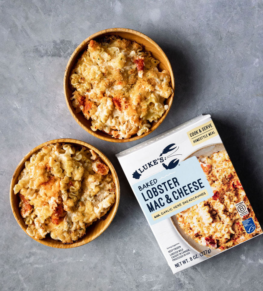 two bowls of lobster mac and cheese next to a package of our branded lobster mac and cheese dish